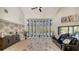 Spacious living room with a curved wall of windows, pool view, and seating at 269 Pine Ranch Trl, Osprey, FL 34229