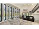 Living area with wall of windows overlooking the pool at 269 Pine Ranch Trl, Osprey, FL 34229
