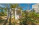 Covered outdoor kitchen area with a fan at 269 Pine Ranch Trl, Osprey, FL 34229
