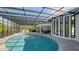 Expansive, oval pool with a screened enclosure and patio at 269 Pine Ranch Trl, Osprey, FL 34229
