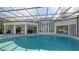 Spacious pool area with covered patio and outdoor kitchen at 269 Pine Ranch Trl, Osprey, FL 34229