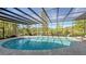 Expansive pool with covered patio and screened enclosure, providing shade and privacy at 269 Pine Ranch Trl, Osprey, FL 34229