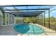 Covered patio with pool and lush landscaping, creating a serene atmosphere at 269 Pine Ranch Trl, Osprey, FL 34229