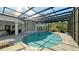 Stunning oval pool with screened enclosure and patio furniture at 269 Pine Ranch Trl, Osprey, FL 34229