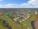 High-level aerial of community near golf course and bodies of water at 310 Wexford Ter # 164, Venice, FL 34293