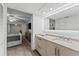 Clean bathroom with a large vanity and a view of the bedroom at 310 Wexford Ter # 164, Venice, FL 34293