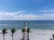 Scenic beach view with pier, palm trees, and ocean at 310 Wexford Ter # 164, Venice, FL 34293