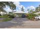 House exterior with carport and nicely landscaped yard at 310 Wexford Ter # 164, Venice, FL 34293