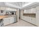 Kitchen with white cabinets, granite countertops, and stainless steel appliances at 310 Wexford Ter # 164, Venice, FL 34293