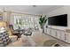 Relaxing living room with comfortable seating and sliding glass doors leading to a patio at 310 Wexford Ter # 164, Venice, FL 34293