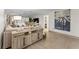 Living room featuring a sectional sofa and stylish wood accent cabinet at 310 Wexford Ter # 164, Venice, FL 34293