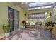Cozy patio with seating area, plants, and stone accents at 310 Wexford Ter # 164, Venice, FL 34293