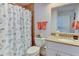 Clean bathroom with seashell shower curtain and granite vanity at 3404 Falcon Pl, Bradenton, FL 34210