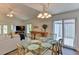 Bright dining area with glass table and seating for six, adjacent to living room at 3404 Falcon Pl, Bradenton, FL 34210