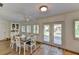 Bright dining area with a rustic wooden table and access to backyard at 3404 Falcon Pl, Bradenton, FL 34210
