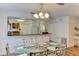 Charming dining room featuring a glass table and open kitchen view at 3404 Falcon Pl, Bradenton, FL 34210