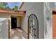 Inviting entryway with a decorative wrought-iron gate and brick pathway at 3404 Falcon Pl, Bradenton, FL 34210