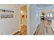 Hallway with light walls and wood-look flooring leads to bathroom at 3404 Falcon Pl, Bradenton, FL 34210