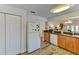 White appliances and wood cabinets in this galley-style kitchen at 3404 Falcon Pl, Bradenton, FL 34210