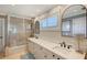Bathroom with double vanity and a tub shower combo at 3408 Fair Oaks Ln, Longboat Key, FL 34228