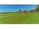 Expansive green golf course with lush landscaping at 3408 Fair Oaks Ln, Longboat Key, FL 34228