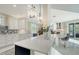 Open kitchen boasts white cabinets, quartz countertops and breakfast bar at 3408 Fair Oaks Ln, Longboat Key, FL 34228