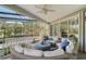 Covered patio with circular seating and golf course views at 3408 Fair Oaks Ln, Longboat Key, FL 34228