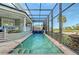 Inviting pool area with spa and screened enclosure, overlooking a golf course at 3408 Fair Oaks Ln, Longboat Key, FL 34228