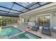 Inviting pool and spa area with a covered patio at 3408 Fair Oaks Ln, Longboat Key, FL 34228