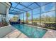 Refreshing pool with screened enclosure and lush landscaping at 3408 Fair Oaks Ln, Longboat Key, FL 34228