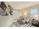 Relaxing sitting area with two armchairs, ottomans, and a window with shutters at 3408 Fair Oaks Ln, Longboat Key, FL 34228