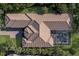 Aerial view of a single-Gathering home highlighting its tile roof, pool, and backyard surrounded by tropical landscaping at 3769 Caledonia Ln, Sarasota, FL 34240