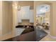 View of the bar with a chandelier, sleek countertops, sink, and cabinets conveniently located off of the living room at 3769 Caledonia Ln, Sarasota, FL 34240