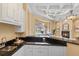 Entertain in style with this bar featuring sleek countertops, sink, and cabinets conveniently located by the living room at 3769 Caledonia Ln, Sarasota, FL 34240