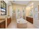 Bright bathroom with a soaking tub, dual vanities, and separate shower stalls for a spa-like experience at 3769 Caledonia Ln, Sarasota, FL 34240