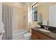 Bright bathroom featuring a shower-tub combination and granite topped vanity at 3769 Caledonia Ln, Sarasota, FL 34240