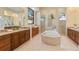 Spacious bathroom with a soaking tub, dual vanities, and separate shower stalls for a spa-like experience at 3769 Caledonia Ln, Sarasota, FL 34240