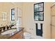 Bathroom with granite vanity, framed art, and window at 3769 Caledonia Ln, Sarasota, FL 34240