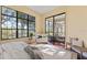 Bright bedroom featuring large window, sliding glass doors and a cozy sitting area at 3769 Caledonia Ln, Sarasota, FL 34240