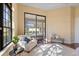 Bright bedroom featuring large window, sliding glass doors and a cozy sitting area at 3769 Caledonia Ln, Sarasota, FL 34240
