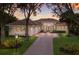 Luxury home with brick driveway, three-car garage, and landscaped yard at 3769 Caledonia Ln, Sarasota, FL 34240