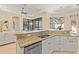 Well-lit kitchen features granite counters, stainless appliances, and views to the patio at 3769 Caledonia Ln, Sarasota, FL 34240
