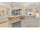 Modern kitchen with granite countertops, island, and stainless steel appliances at 3769 Caledonia Ln, Sarasota, FL 34240