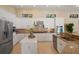 Bright kitchen features white cabinets, stainless steel appliances, granite counters, and an island at 3769 Caledonia Ln, Sarasota, FL 34240