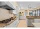Modern kitchen showcasing stainless appliances, granite counters and view to living area at 3769 Caledonia Ln, Sarasota, FL 34240