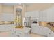 Gourmet kitchen featuring stainless steel appliances, granite countertops, and custom cabinetry at 3769 Caledonia Ln, Sarasota, FL 34240