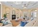 Inviting living room with fireplace, tray ceiling, and a seamless flow to other living spaces at 3769 Caledonia Ln, Sarasota, FL 34240