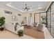 Bright living room featuring large windows and sliding doors that provide access to an enclosed lanai at 3769 Caledonia Ln, Sarasota, FL 34240