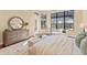 Elegant main bedroom boasting wood floors, dresser and a large window that fills the room with natural light at 3769 Caledonia Ln, Sarasota, FL 34240
