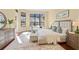 Bright main bedroom featuring dark wood floors, large windows, and a cozy sitting area for a peaceful retreat at 3769 Caledonia Ln, Sarasota, FL 34240